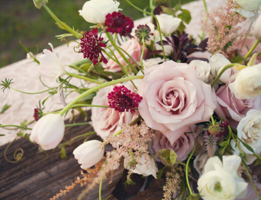Lush garden inspired valentine's blooms including blush pink roses and astilbe, burgundy scabiosa and white tulips